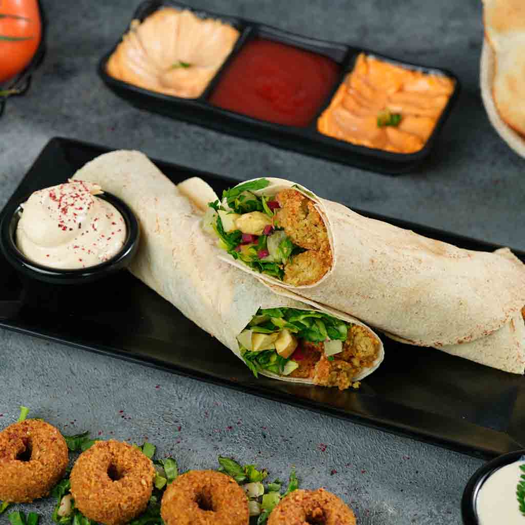 sandwich falafel shamiyah with eggs and hummus