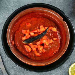 Meat in tray with tomatoes